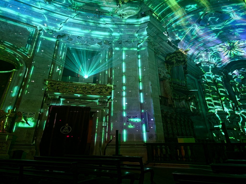 Immersive Spiritus show at Clerigos Church in Porto with animated images projected across walls.